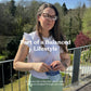 Woman opening a Nooroots supplement pouch outdoors as part of a balanced lifestyle.