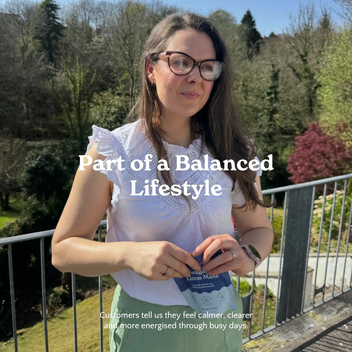Woman opening a Nooroots supplement pouch outdoors as part of a balanced lifestyle.