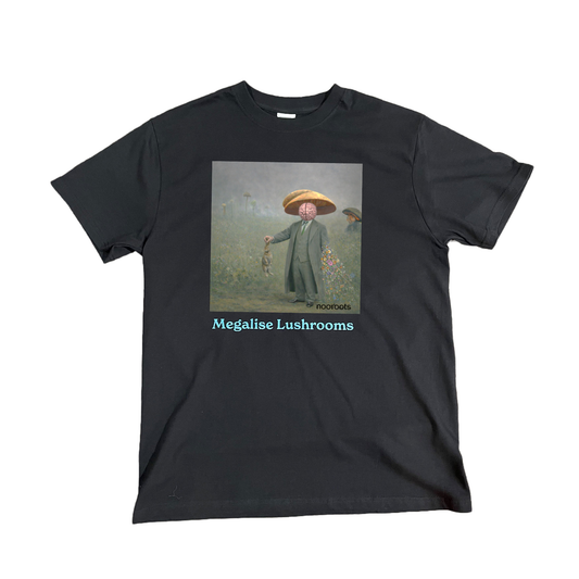 Black T-shirt featuring surreal artwork of a man in a mushroom hat holding a rabbit, with a brain covering part of his face and flowers flowing from his arm, titled “Megalise Lushrooms.