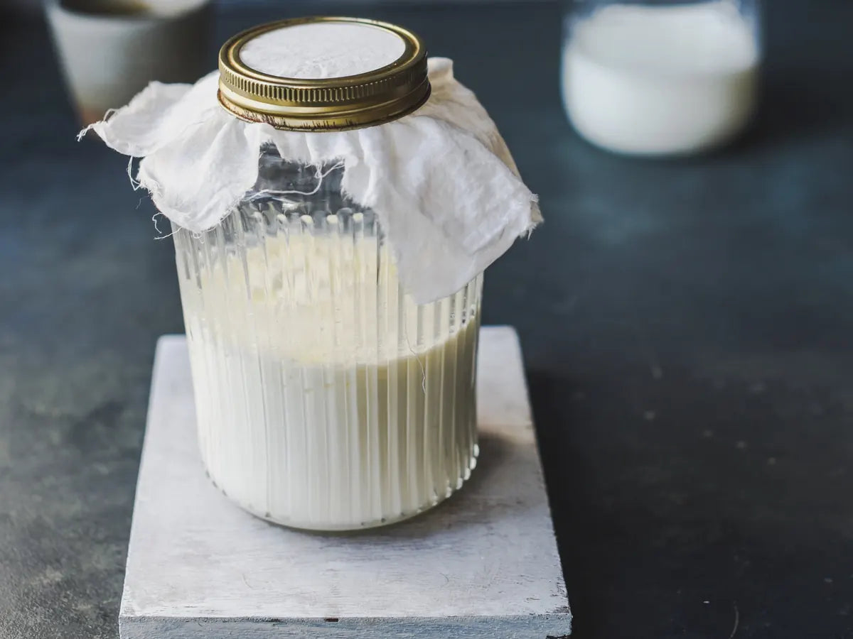 Jar of milk covered with a cloth