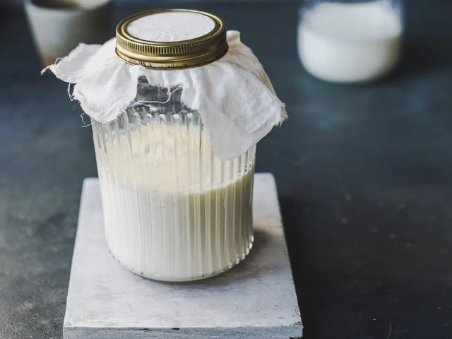 Jar of milk covered with a cloth