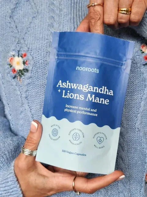 Hands holding a pouch of Ashwagandha & Lion's Mane against a knitted jumper
