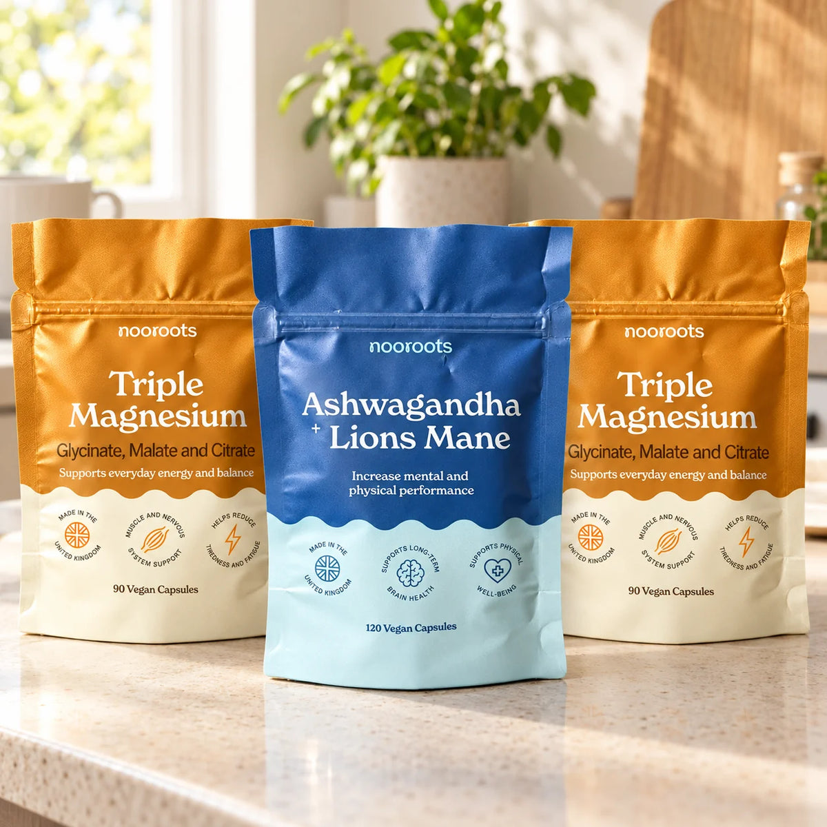 Ashwagandha + Lion's Mane pouch with two Triple Magnesium pouches on a sunny kitchen worktop