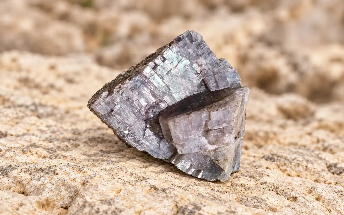 Raw magnesium ore crystal resting on warm limestone