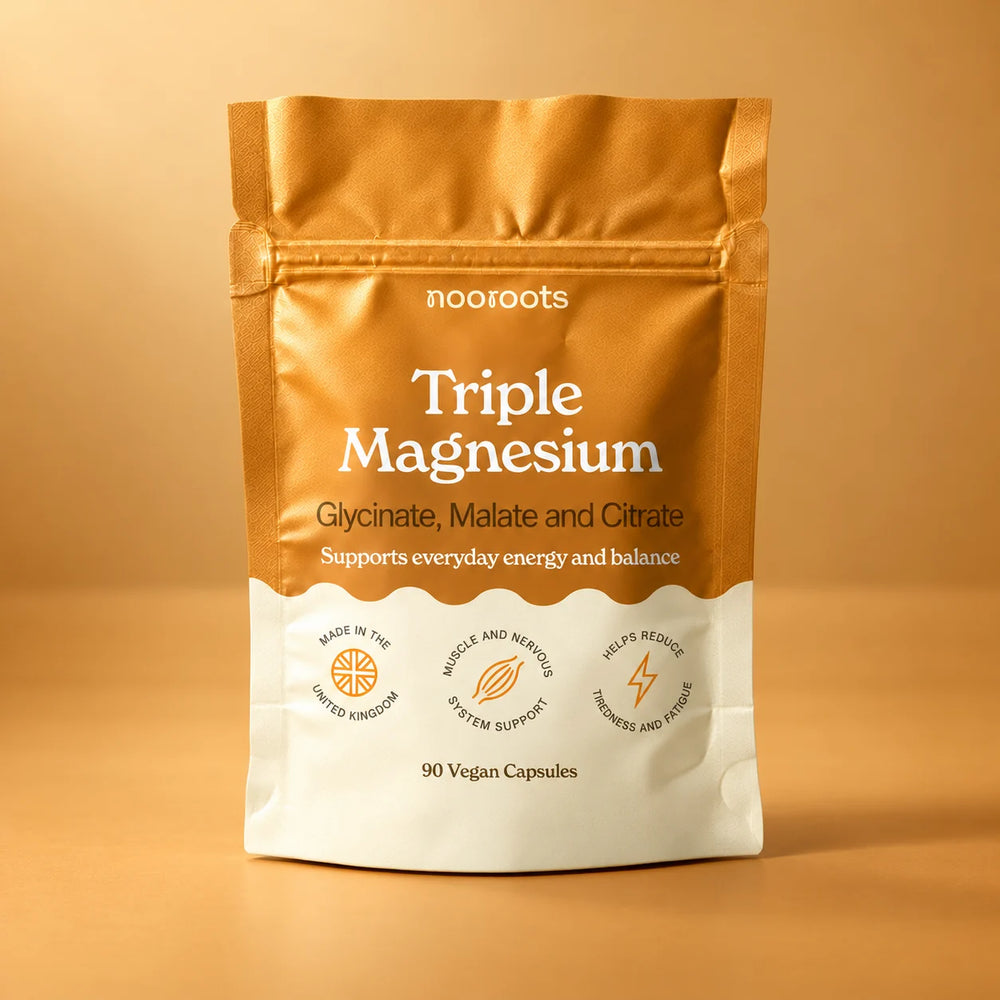 Nooroots Triple Magnesium pouch, 90 vegan capsules, on a warm amber studio background